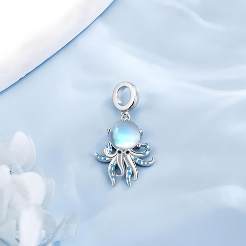 925 sterling silver moonstone octopus pendant with blue gemstone accents hanging on a light blue background