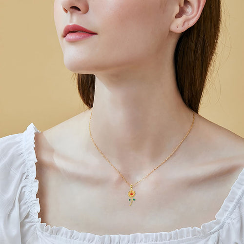 Origsoul 925 sunflower pendant for women worn on a gold chain by a model in a white top