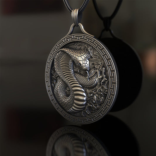 Origsoul artisan crafted snake jewelry featuring a detailed silver snake pendant with intricate scales and a Greek key border