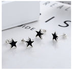 Origsoul cosmic nautical star stud earrings with black enamel and silver finish set on white background