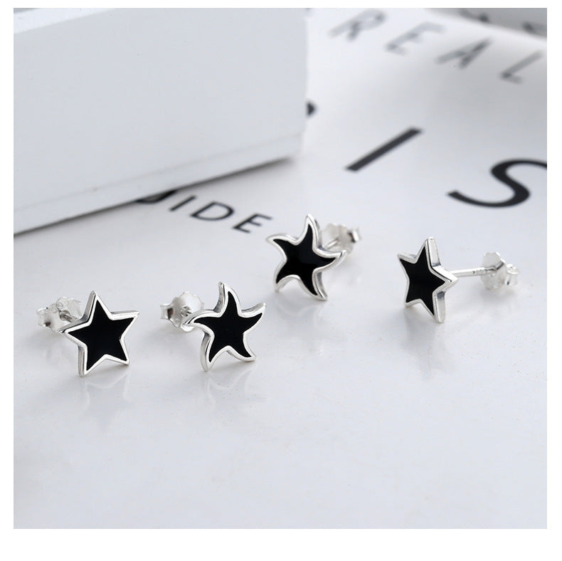 Origsoul cosmic nautical star stud earrings with black enamel and silver finish set on white background