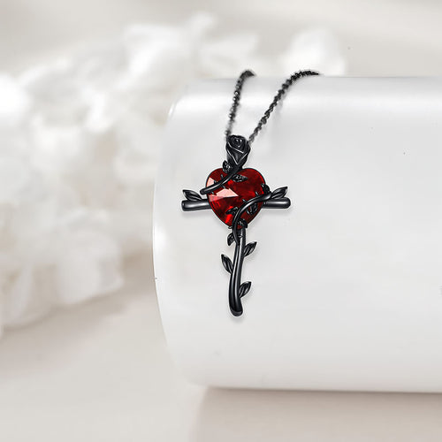 Black rose sterling silver necklace featuring a red heart design with intricate rose details