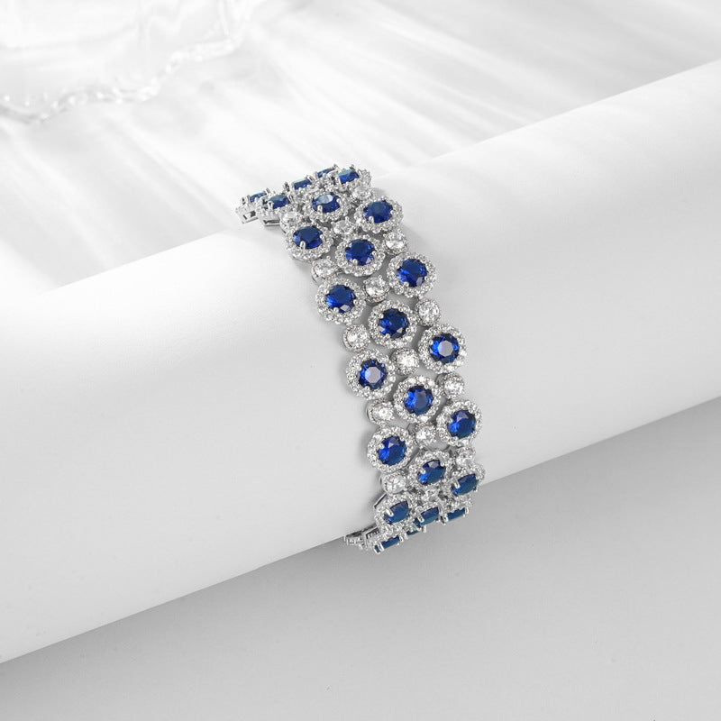Origsoul bracelet tennis diamond with blue gemstones and silver settings on white background