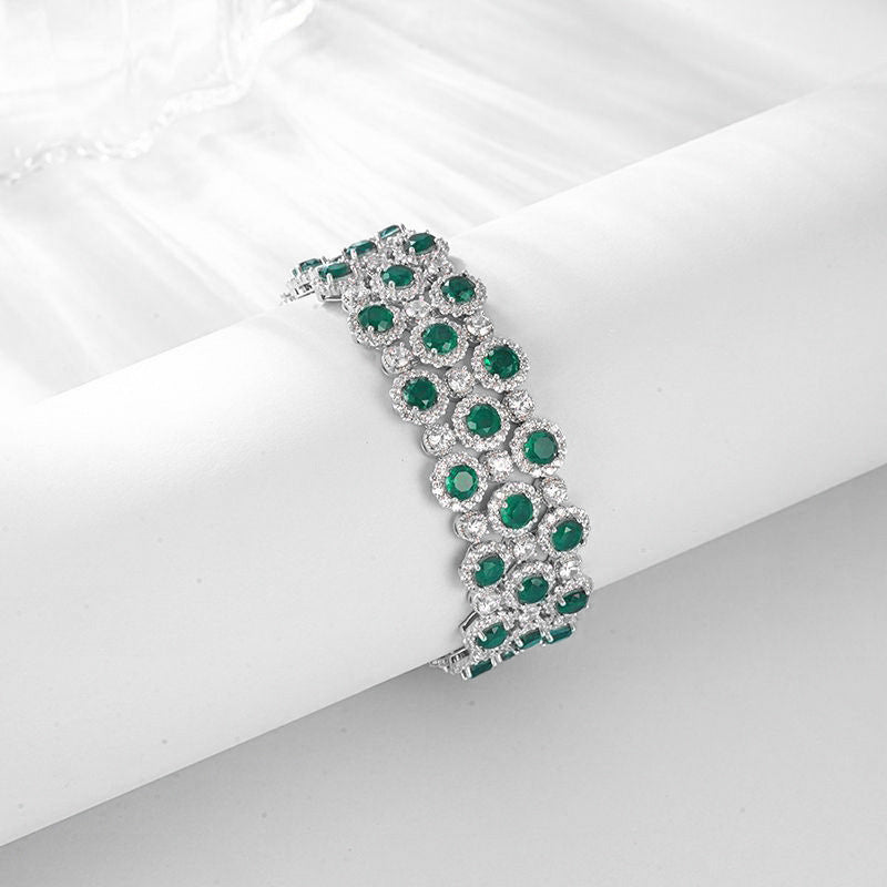Origsoul bracelet tennis diamond with green emerald gemstones and silver setting on white background