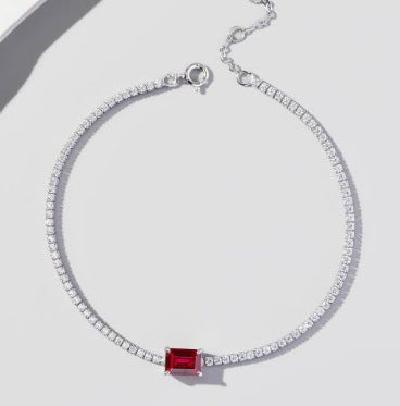Origsoul bracelet with emerald featuring a silver chain and a rectangular red gemstone centerpiece
