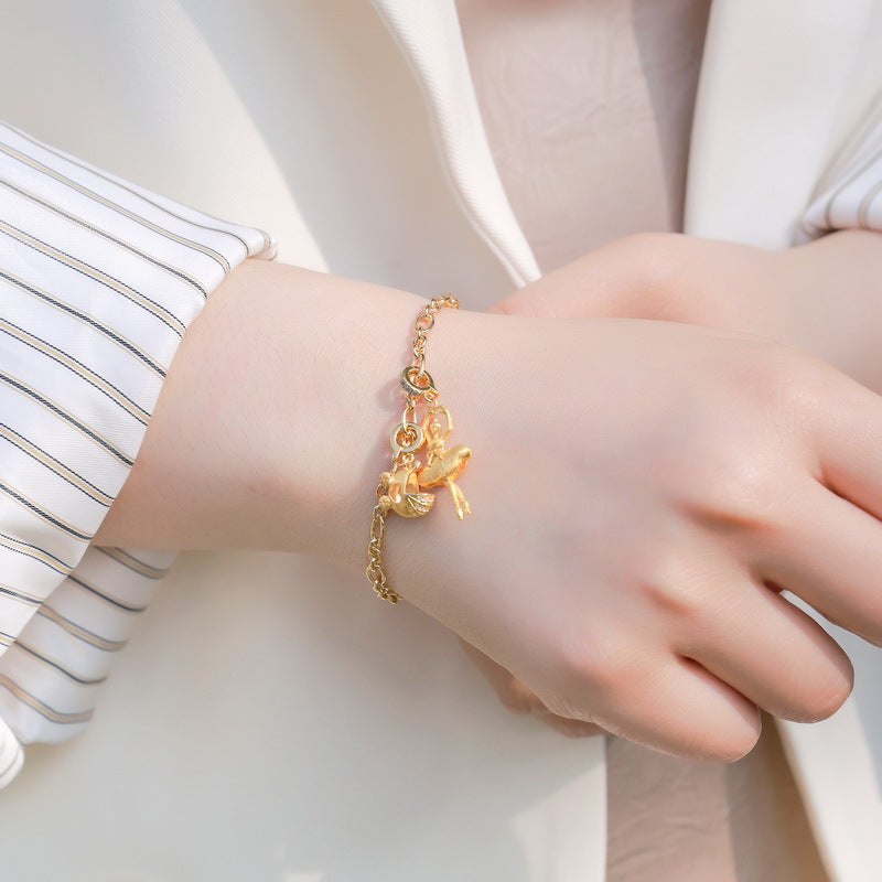 Origsoul gold charm bracelet worn on wrist, elegant jewelry piece complementing sterling silver necklace