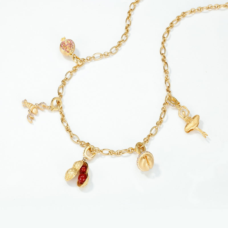 Origsoul sterling silver necklace with gold-tone chain and unique charm pendants including peanut and ballerina