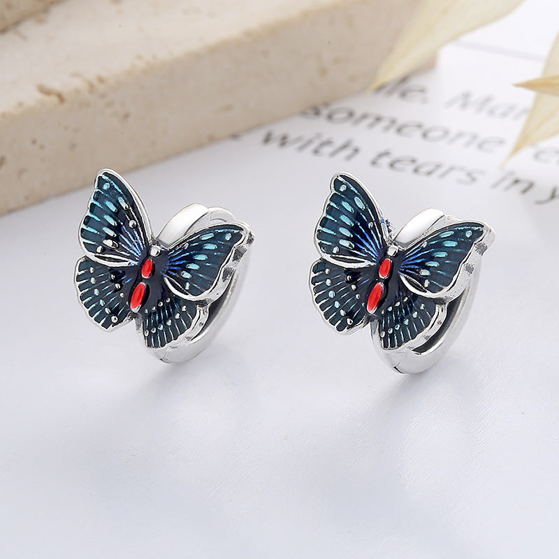 Origsoul butterfly earrings for women with detailed blue and red enamel design on silver hoops