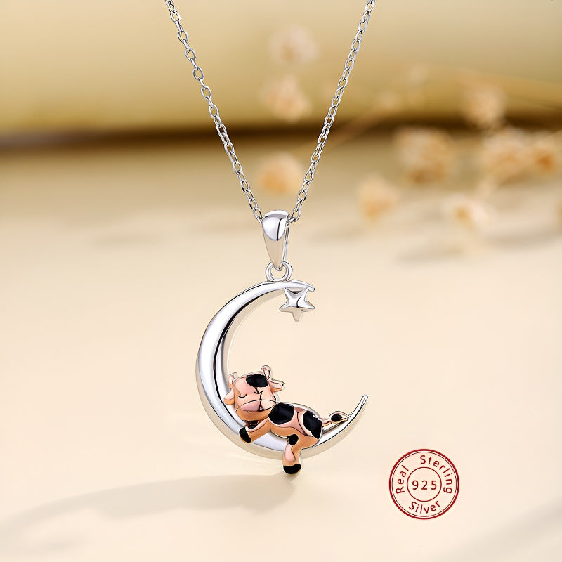 Cartoon cow moon pendant necklace in sterling silver with a playful cow on a crescent moon