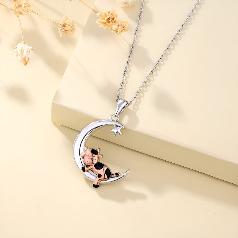 Cartoon cow moon pendant necklace with a playful cow sitting on a crescent moon