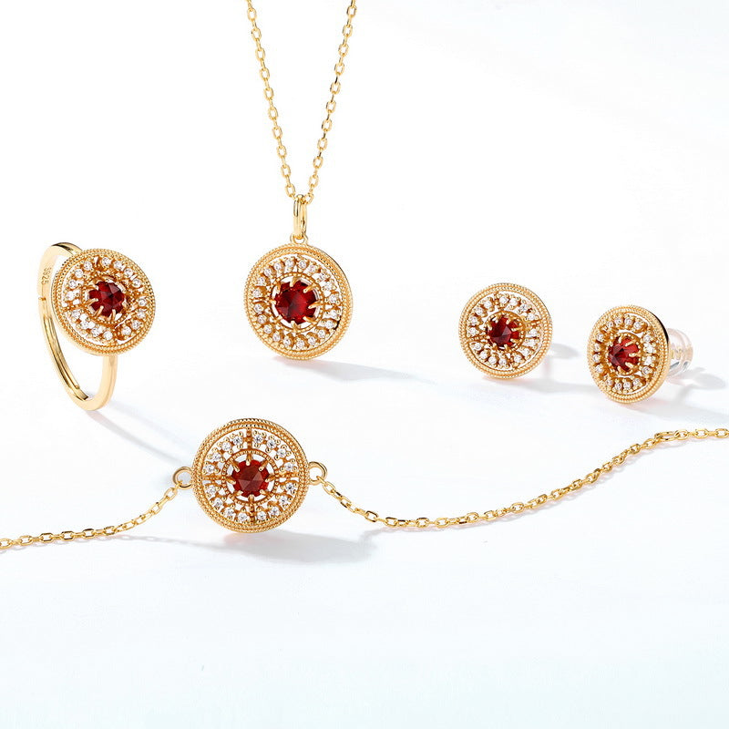 Origsoul jewelry set including ring, necklace, bracelet, and chanel vintage earrings with red stones and gold detailing