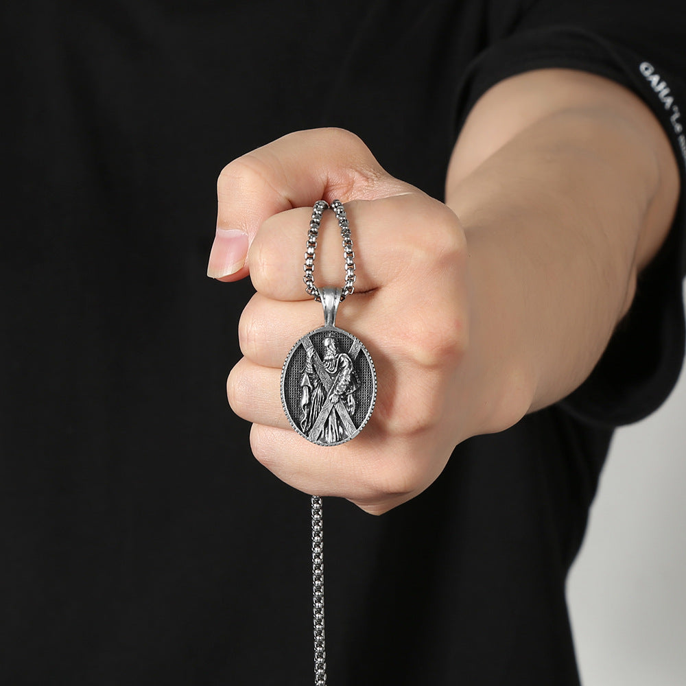 Christian saint necklace gift from Origsoul Tranquil Spirit Collection held in hand with detailed silver pendant
