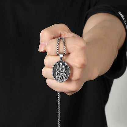 Christian saint necklace gift from Origsoul Tranquil Spirit Collection held in hand with detailed silver pendant