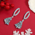 Origsoul silver Christmas tree hoop earrings with green and blue gemstones on red background