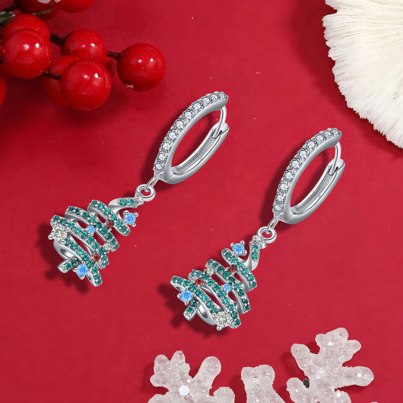 Origsoul silver Christmas tree hoop earrings with green and blue gemstones on red background