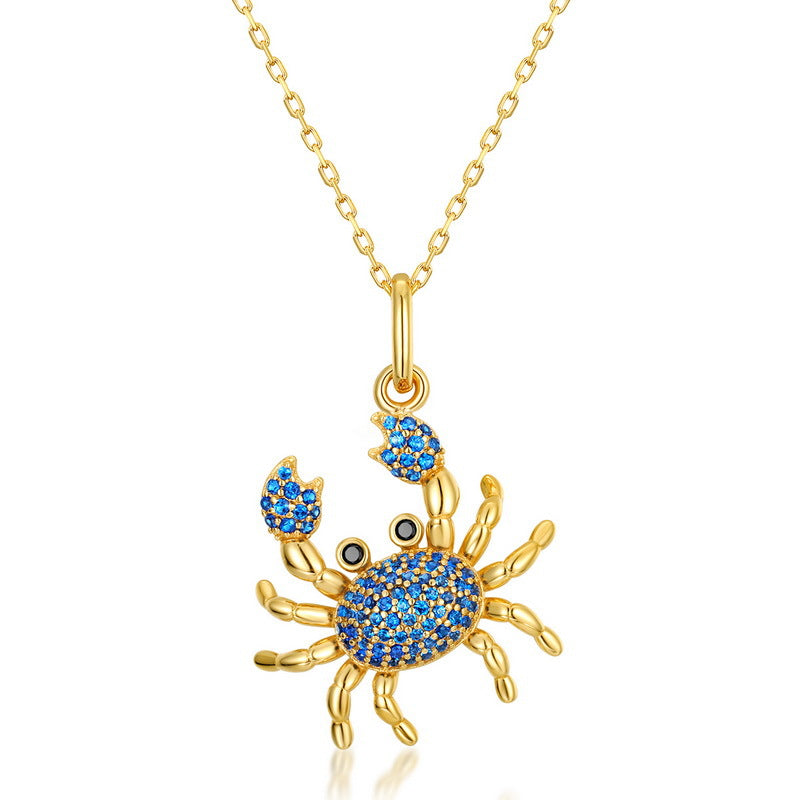 Origsoul gold crab pendant with blue stones on a silver necklace sterling chain
