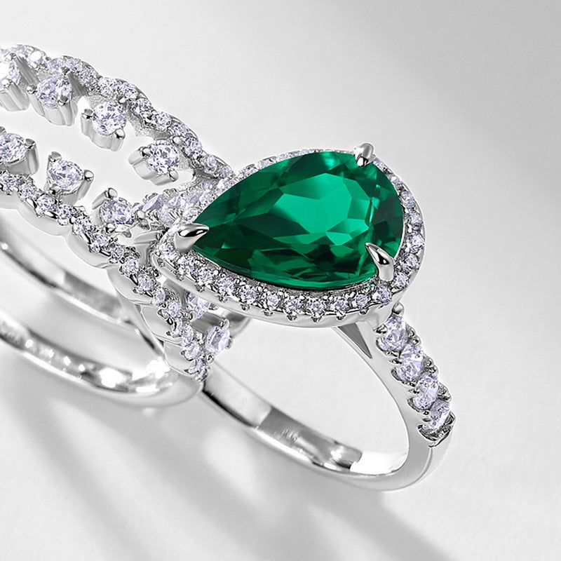 Origsoul engagement ring emerald cut with pear-shaped green gemstone and diamond accents on silver band