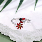 Origsoul colorful ladybug ring with red flower and silver band on white textured surface