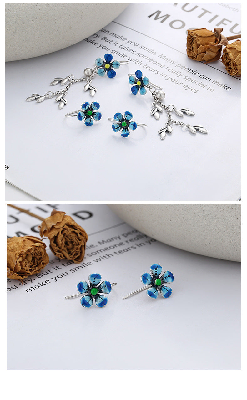 Origsoul daisy tassel earrings with blue flower design and silver leaf charms on white background