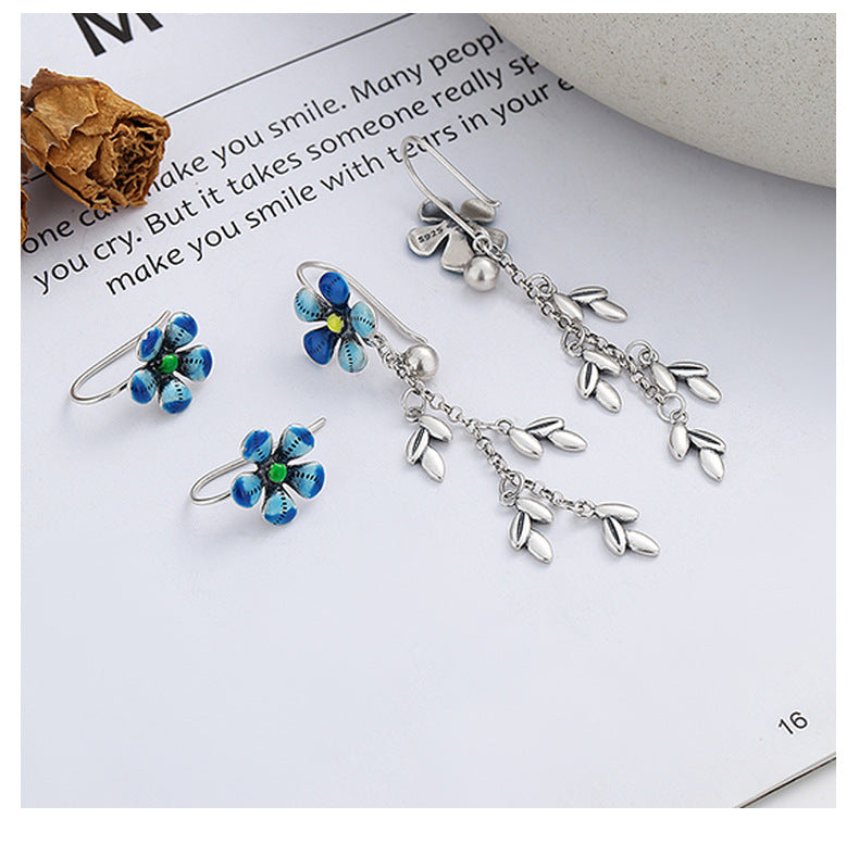 Origsoul daisy tassel earrings featuring blue flower studs and delicate silver leaf chain details