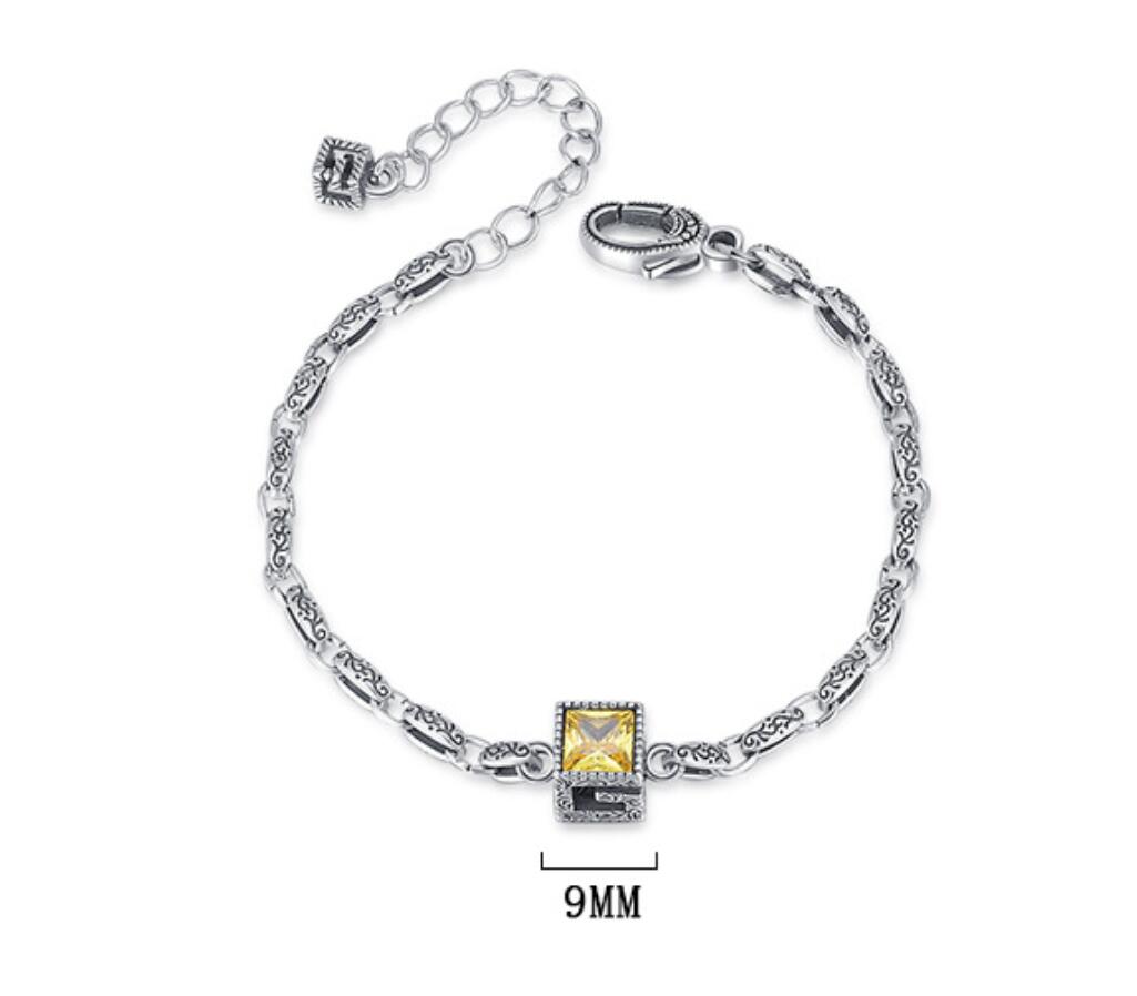 Origsoul designer embossed chain bracelet in silver with a yellow square gemstone centerpiece