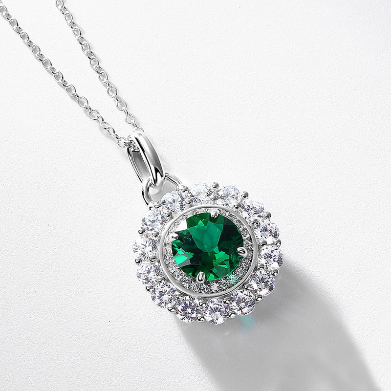 Origsoul emerald necklace featuring a round green emerald center surrounded by sparkling clear stones on a silver chain