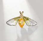 Elegant nature-inspired brooch featuring a butterfly design with yellow gemstone and intricate wing details