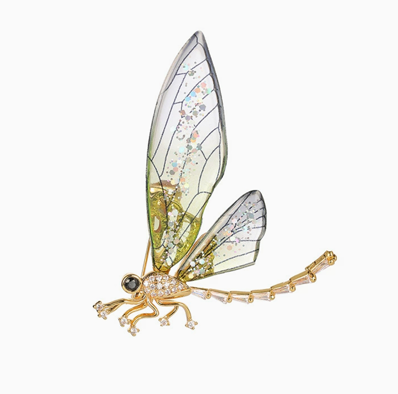 Elegant nature-inspired brooch featuring a dragonfly design with sparkling accents and intricate wings