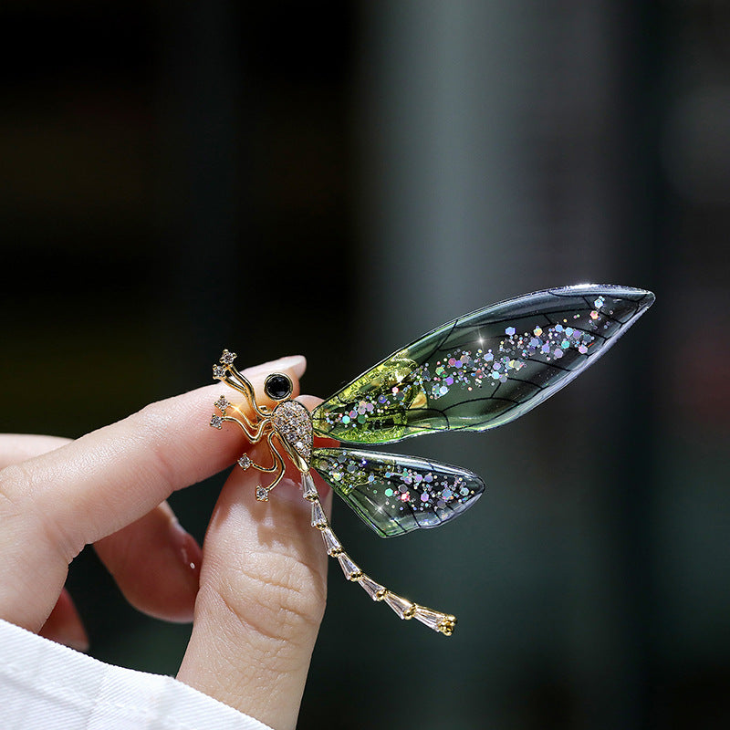 Elegant nature-inspired brooch featuring a colorful insect design with intricate detailing