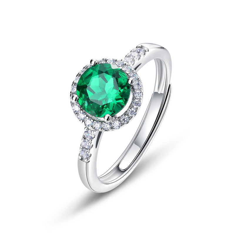 Origsoul emerald cut wedding ring with a vibrant green center stone and diamond accents on silver band