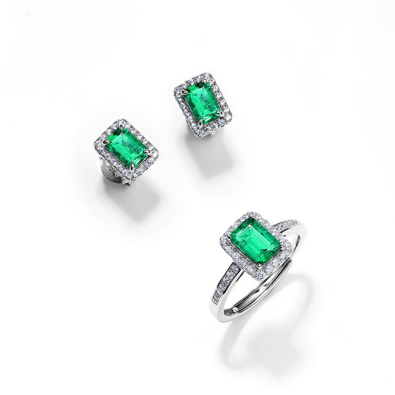 Origsoul ear stud earrings with rectangular green emerald center stones surrounded by small clear crystals