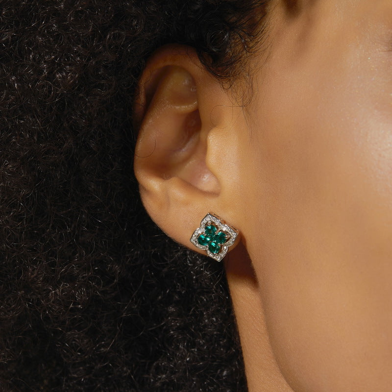 Origsoul emerald earrings earrings with green gemstones and silver setting worn on ear