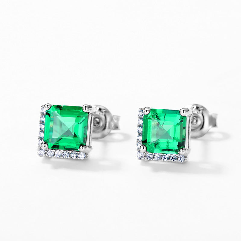 Origsoul emerald earrings with square green gemstones and surrounding small white crystals in silver setting