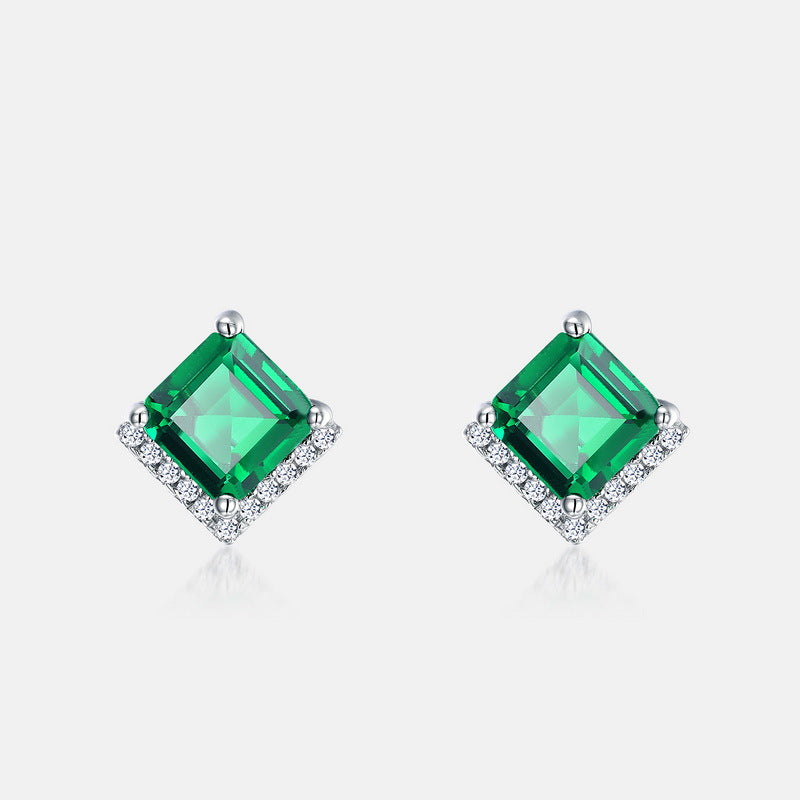 Origsoul emerald earrings with square green gemstones surrounded by small clear crystals