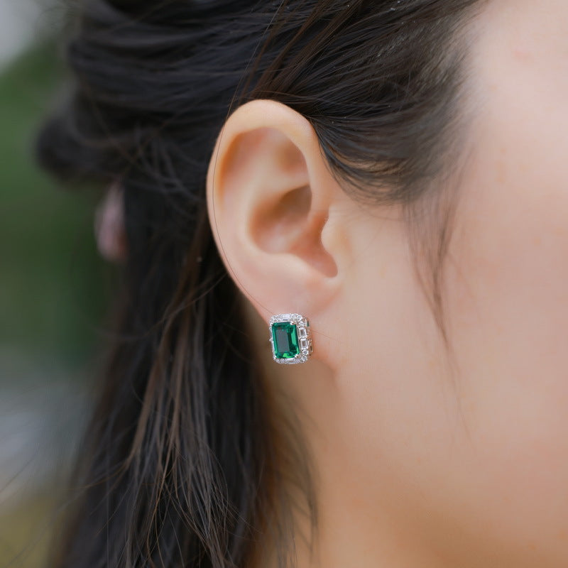 Origsoul emerald earrings stud featuring a rectangular green gemstone surrounded by small diamonds