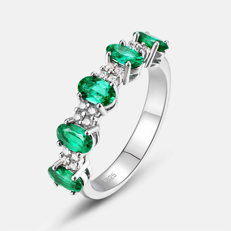 Origsoul silver ring with emerald engagement ring cut stones and small clear accent gems