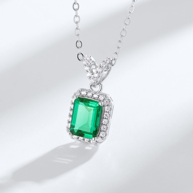 Origsoul emerald necklace with rectangular green gemstone surrounded by small diamonds on silver chain