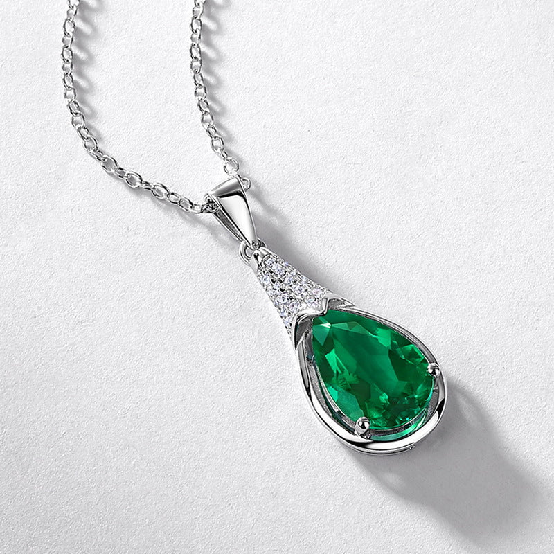Origsoul emerald necklace with pear-shaped green gemstone and silver chain with small clear crystals