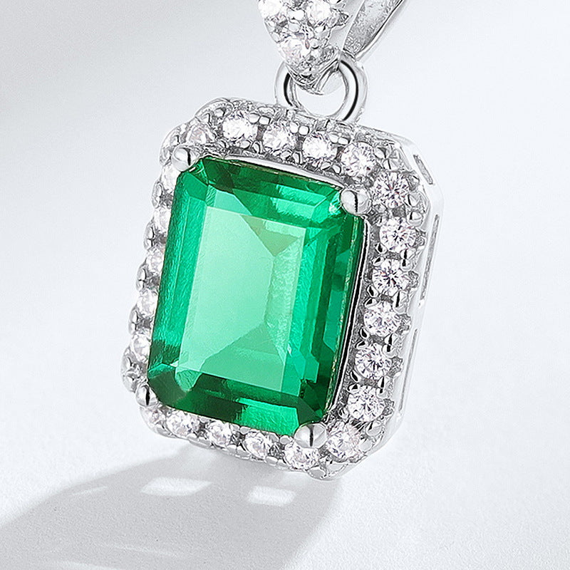 Origsoul emerald necklace featuring a rectangular green emerald surrounded by sparkling white stones
