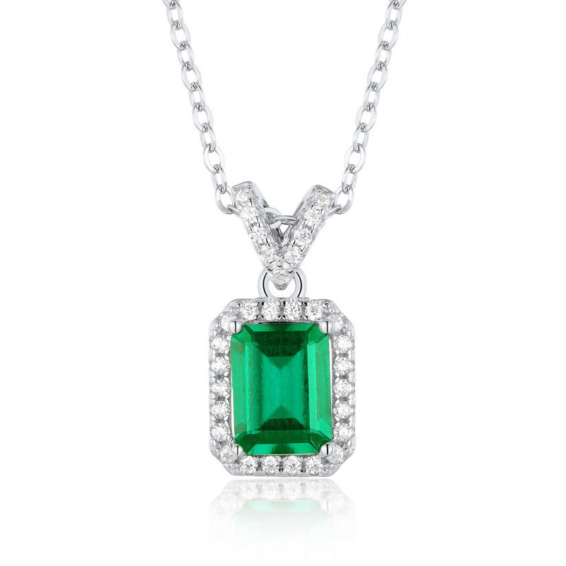 Origsoul emerald necklace with rectangular green gemstone surrounded by small clear crystals on silver chain