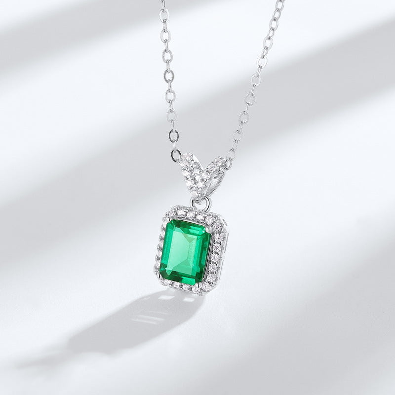 Origsoul emerald necklace with rectangular green gemstone and surrounding clear crystals on silver chain