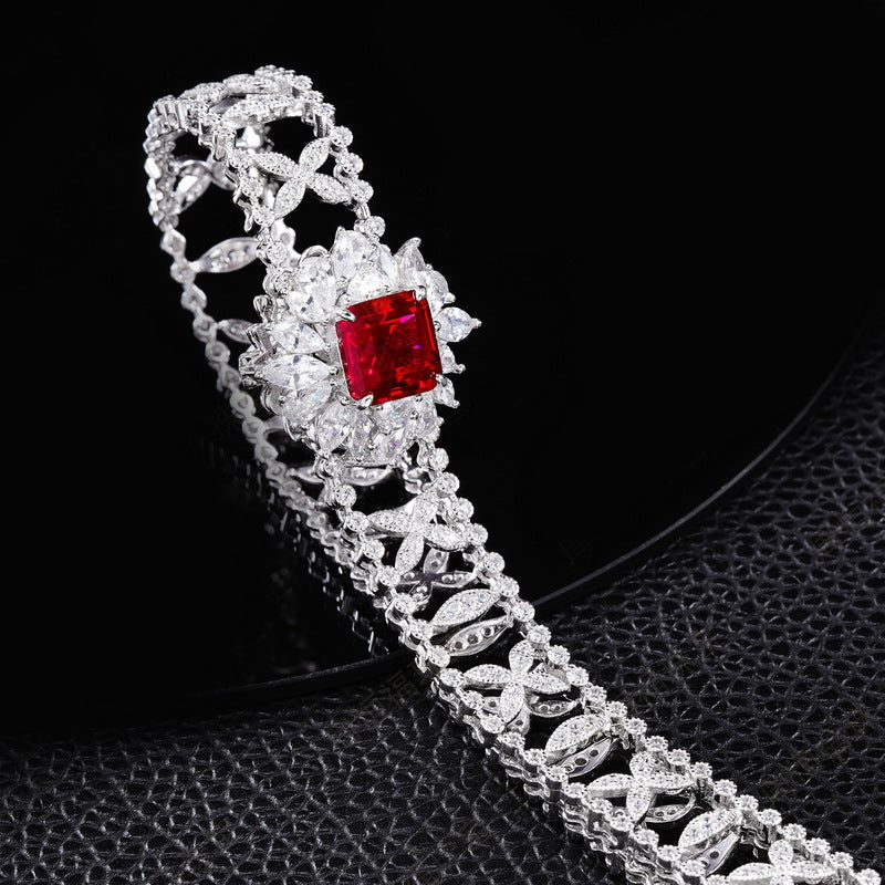 Origsoul jewelry bracelet with intricate silver design and a red center gemstone, not an emerald necklace