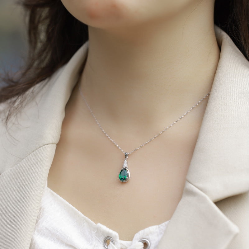 Origsoul elegant emerald necklace with teardrop pendant worn on a silver chain by a woman