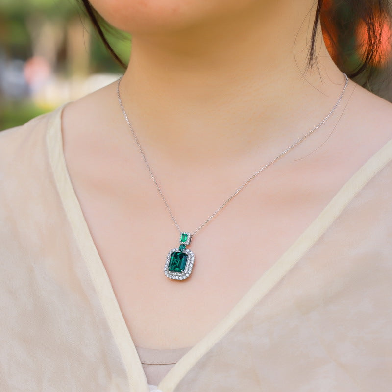 Origsoul emerald necklace with silver chain and rectangular green gemstone pendant worn on neck