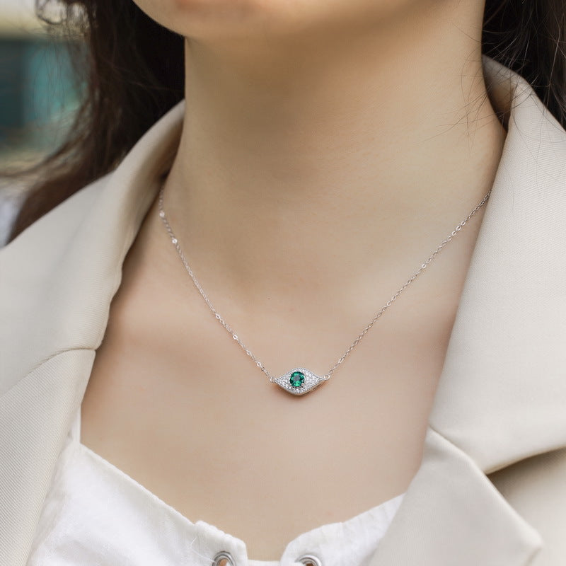 Origsoul emerald necklace with silver chain and green gemstone pendant worn on model's neck
