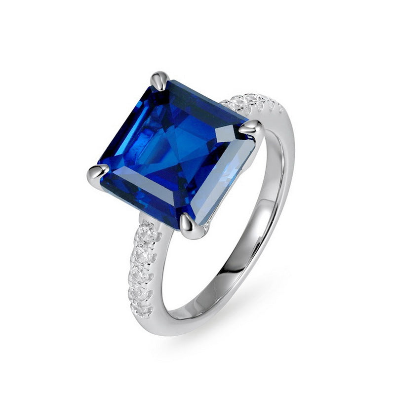 Origsoul engagement ring emerald cut with large blue gemstone and small side diamonds on silver band