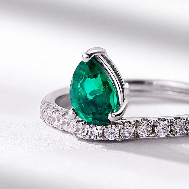 Origsoul engagement ring emerald cut with pear-shaped emerald center and diamond-studded silver band