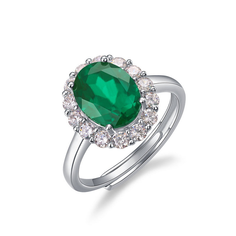 Origsoul engagement ring emerald cut featuring a large green gemstone surrounded by smaller clear stones on a silver band