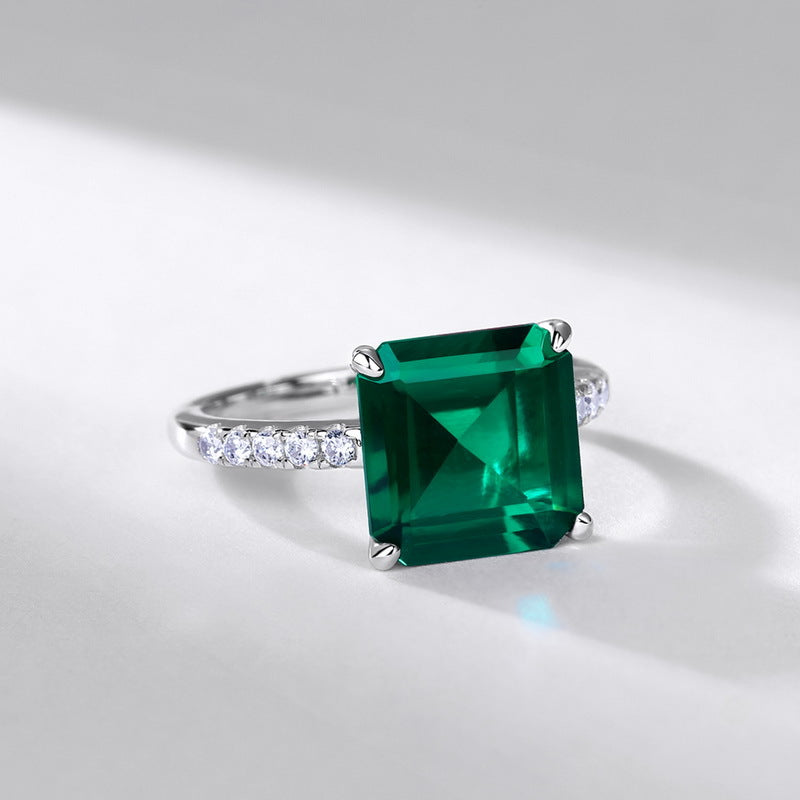 Origsoul engagement ring emerald cut with a large green emerald and diamond accents on a silver band