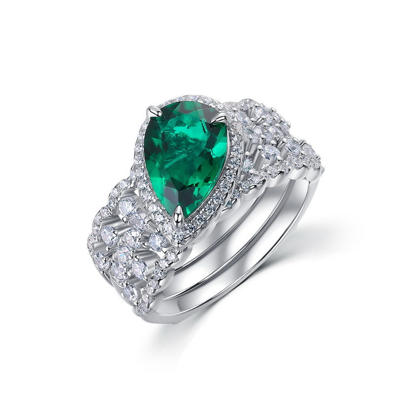 Origsoul engagement ring emerald cut with pear-shaped green emerald and diamond accents